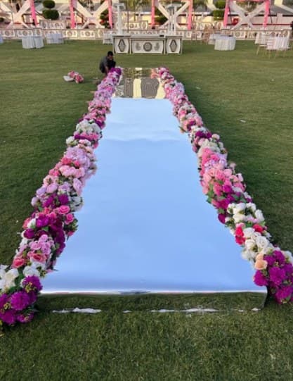 Mirror aisle on a lawn bordered with pink and purple flowers