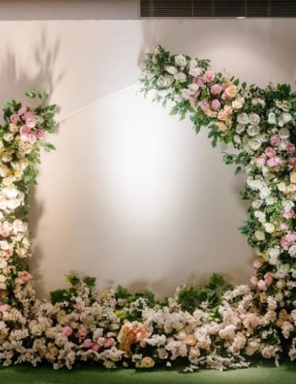 Soft-lit backdrop framed with white and pink roses