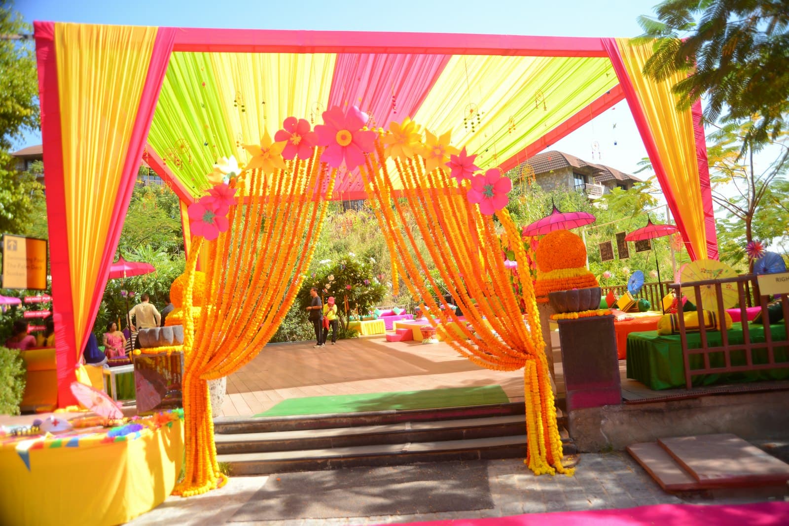 Haldi entrance with marigold garlands, yellow drapes and paper flowers